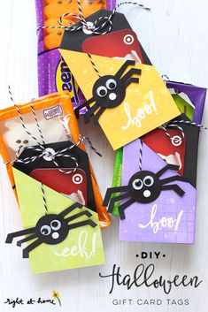 four halloween treat bags with spider tags on them