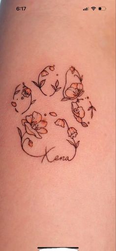 a woman's thigh with flowers on it and the word love written in cursive writing