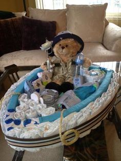 a teddy bear sitting in a baby's bassinet filled with diapers