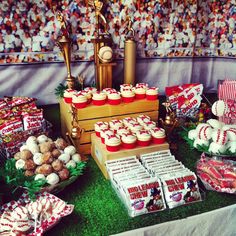 a table topped with lots of cupcakes and treats