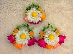 three flower bouquets are arranged on a white furnishing