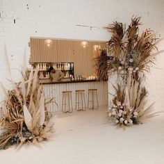 the bar is decorated with dried plants and flowers