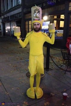 a man in a yellow costume holding two cups