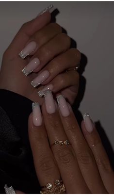 a woman's hands with some manies on their nails and one hand holding the other