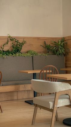 two wooden chairs sitting next to each other on top of a hard wood floored floor