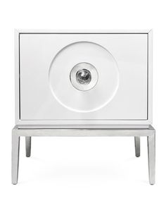 a white cabinet with a metal base and an eyeball in the center, on a white background