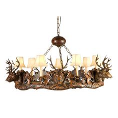 a chandelier with deer heads and candles on it