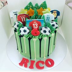 a soccer themed birthday cake with decorations on the top and around it's edges