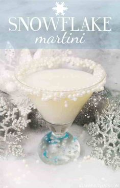 a drink in a glass on top of snowflakes and silver ornaments with the words, snowflake martini