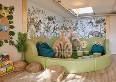 the children's playroom is decorated in green and blue tones with animals on the wall