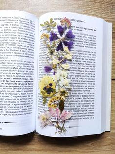 an open book with flowers on it