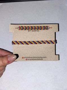 a hand holding a business card with an arrow on it