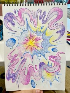 someone is holding up a drawing with colored inks on paper and it looks like they are