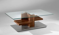 a glass and wood table with metal base