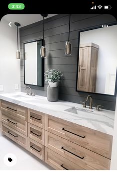 a bathroom with two sinks and mirrors on the wall