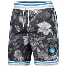 Keep cool in warm weather by wearing these Charlotte FC Printed shorts from The Wild Collective. They feature a floral pattern all over the breathable mesh fabric and a flexible waistband. The Charlotte FC crest is highlighted by the striped trim in club colors. Imported Inseam for size M approx. 7.0" Machine wash, tumble dry low Brand: The Wild Collective One back pocket Embroidered graphics Two side pockets Elastic waistband with drawstring Officially licensed Mesh fabric Material: 100% Polyes Casual Mesh Bottoms For Beach, Casual Mesh Beach Bottoms, Sporty Printed Short Bottoms, Casual Mesh Athletic Shorts For Summer, Breathable Mesh Bottoms For Summer, Blue Mesh Bottoms For Summer, Short Mesh Bottoms For Spring, Spring Bottoms With Built-in Shorts And Mesh Material, Spring Mesh Bottoms With Built-in Shorts