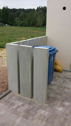 some concrete blocks are stacked on top of each other in the middle of a yard