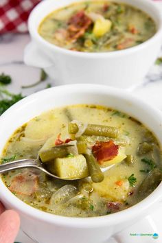 two white bowls filled with soup on top of a table