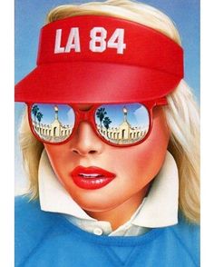 a woman wearing sunglasses and a red hat with the words la84 on it