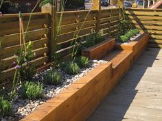 a wooden fence with plants growing in it