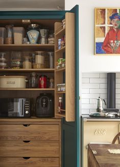 an open cabinet in the corner of a kitchen