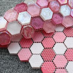 some pink and white hexagonal tiles on the ground