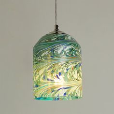 a multicolored glass light hanging from a ceiling