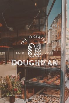 there is a sign that says the greats doughman in front of some pastries