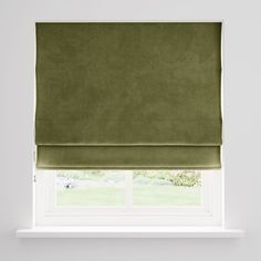 a green roman blind in front of a window