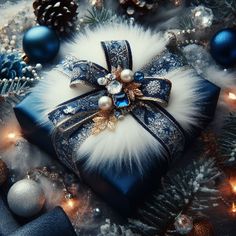 a blue box with a bow on it surrounded by christmas decorations