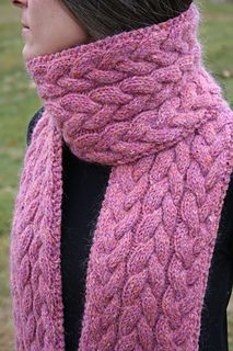 a woman wearing a pink knitted scarf