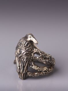 "Crow in the woodland silver ring. Crow as a totem animal is the keeper of sacred law, can see beyond illusion of the physical world and can \"shape shift\". As a guide crow teaches personal integrity, to speak your truth, walk your talk and be truthful to yourself. In creating this ring I was inspired by the mysterious nature of crow that seem to know more than what is on the surface. In the design of the ring I placed the crow on tree twigs and branches, inspecting and watching. Even though th Mystical Open Ring Promise Ring, Hand Forged Symbolic Rings For Collectors, Symbolic Bronze Ring Jewelry, Symbolic Hand Forged Rings For Collectors, Mystical Engraved Silver Rings, Spiritual Collectible Jewelry Rings, Mystical Sterling Silver Rings As Gifts, Ceremonial Symbolic Hand Cast Rings, Collectible Spiritual Jewelry Ring