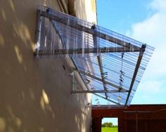 a glass roof attached to the side of a building