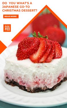 a white plate topped with a piece of cake covered in strawberries