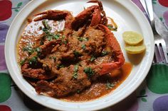 a white plate topped with meat covered in sauce