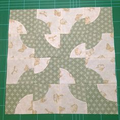 a green cutting board with a piece of fabric on it that has butterflies and stars