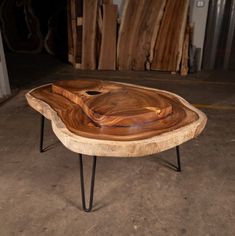 a wooden table with hairpin legs and a tray on it's side in a warehouse