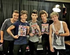 the one direction band is posing for a photo with their magazine covers in front of them