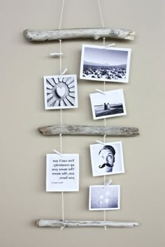 a driftwood wall hanging with pictures on it