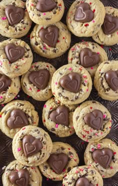 chocolate chip cookies with hearts and sprinkles arranged on a tray for valentine's day