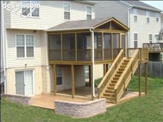 a house with a deck and stairs leading to the second floor