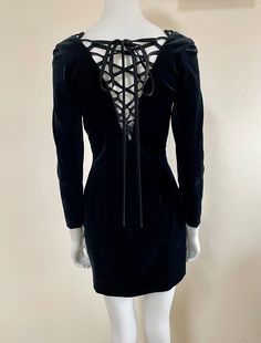 "1990s Moschino Cheap and Chic black velvet lace up cutout mini dress The ties can be styled in different ways Marked size 42 (IT) Best fit: XS - S Made in Italy Condition: Excellent Measurements (taken flat): Shoulders: 38 cm / 15\" Armpits: 40 cm / 15,5\" Waist: 33 cm / 13\" Sleeve length: 53 cm / 21\" Length: 80 cm / 31,5\" -- -- CONDITION GLOSSARY -- -- DEADSTOCK: the item is new, never be worn and it still has the label tag. EXCELLENT: the item is like new, it has no flaws like holes or stains. VERY GOOD / VERY NICE WITH MINOR WEAR: the item is in good condition but it can have some small defects (holes, stains...) We will not allow any return for sizing issues since we provide measurements, make sure to check them carefully and ask any extra one you might need that would not be provi Formal Mini Dress With Lace-up Back, Cutout Mini Dress, Moschino Cheap And Chic, Label Tag, Velvet Lace, Black Velvet, Moschino, Like New, Lace Up