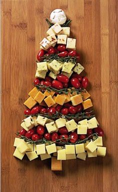 a christmas tree made out of cheese and tomatoes