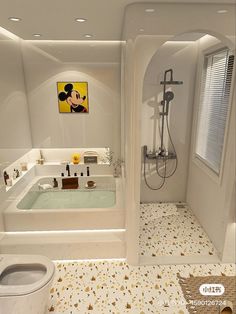 a bathroom with a mickey mouse painting on the wall and a bathtub in the middle