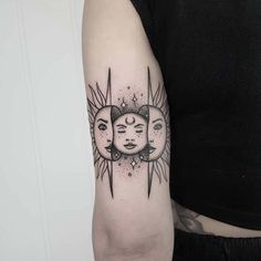 a woman's arm with two sun and moon tattoos on the back of it