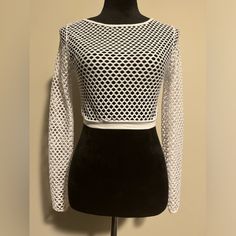 The Fashion Nova White Long Sleeve Mesh Top Is A Sleek And Versatile Piece That Adds A Touch Of Edgy Sophistication To Any Outfit. Whether You Layer It Over A Bralette For A Daring Evening Look Or Style It With High-Waisted Jeans For A Chic Daytime Ensemble, This Mesh Top Is Sure To Turn Heads With Its Modern And Trendy Vibe. Measurements Pit To Pit-15” Length-14.5” Sleeve Length-19.5” From Pit Bin 6 Hollow Out Crop Top For Spring Party, Spring Crop Top With Hollow Out Design, Spring Hollow Out Stretch Crop Top, Stretch Hollow Out Crop Top For Spring, Fitted Hollow Out Crop Top, Long Sleeve Hollow Out Crop Top For Spring, Spring Long Sleeve Hollow Out Crop Top, White Hollow Out Fitted Tops, Stretch Mesh Top With Hollow Out For Night Out