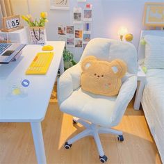 a teddy bear pillow sitting on top of a chair in front of a computer desk