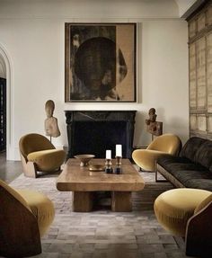 a living room filled with furniture and a painting on the wall above it's fireplace