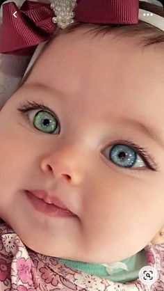 a close up of a baby with blue eyes