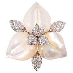 Three carved mother-of-pearl petals are enhanced by diamond leaves, and a diamond foliate cluster center, all in 18 karat white gold. Total stated weight is approximately 1.91 carats. Secured with a double stem pin and plunger clasp. Purchased from famed London Designer David Morris, this brooch has a current Retail Replacement Value of $16,200 as stated by David Morris. Museum Statues, Brooch Diamond, David Morris, Rings Pearl, Fine Pearl Jewelry, Bijoux Art Nouveau, Victorian Engagement Rings, Pearl Engagement Ring, Vintage Jewellery Rings